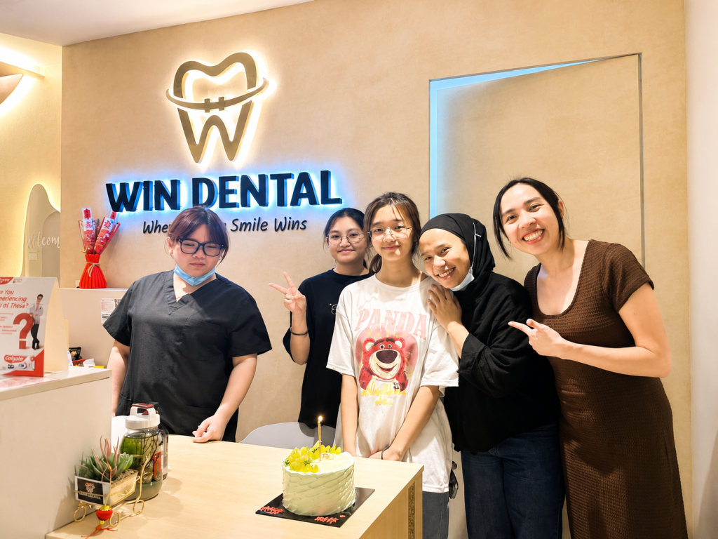 Reception area at Win Dental Clinic dentists and nurses celebrating together during a team event.